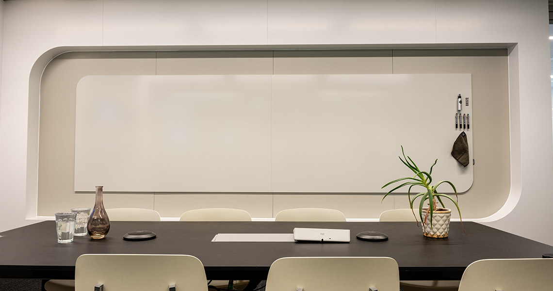 Rounded-corner bespoke whiteboard wall panel in a boardroom