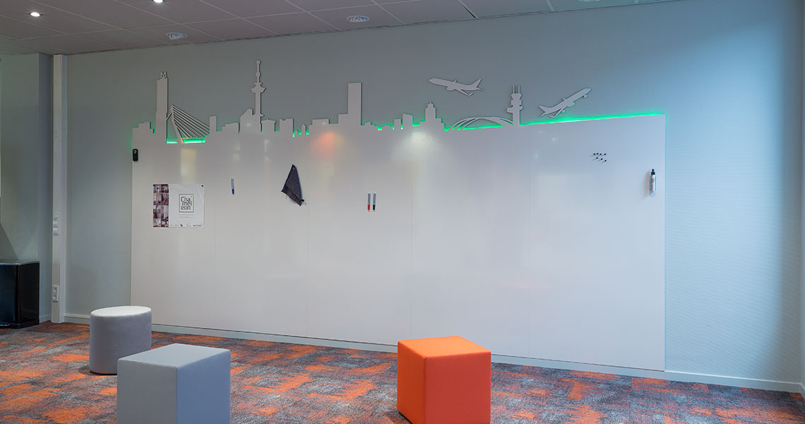 Wide view of a bespoke whiteboard wall with skyline silhouette and seating