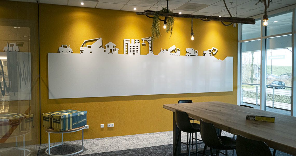 Wide view of a construction-themed cutout whiteboard wall on a mustard wall
