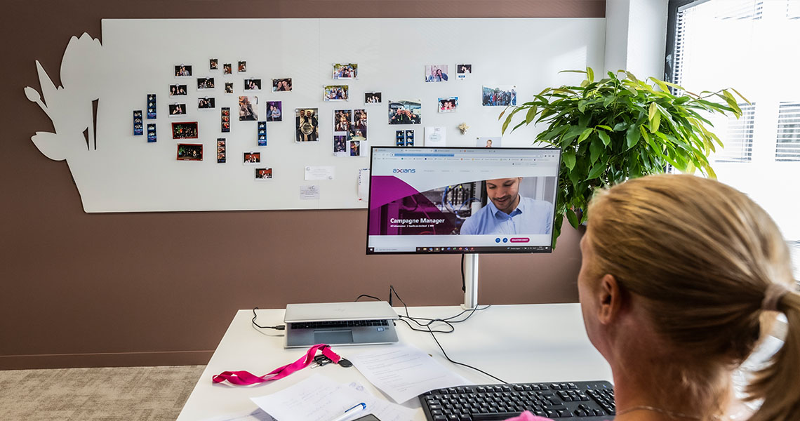 Colleague pinning reference photos to a bespoke whiteboard wall