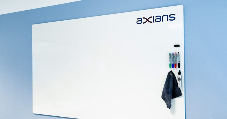 Custom whiteboard with company branding in a blue-toned meeting room