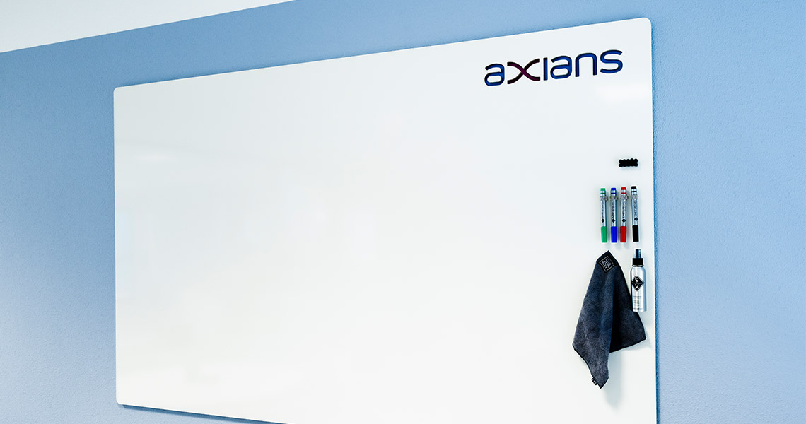 Custom whiteboard with company branding in a blue-toned meeting room