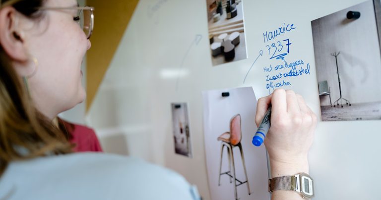 Custom whiteboard wall with pinned reference photos and swatches