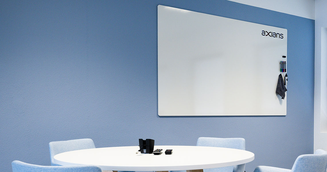 Custom branded whiteboard mounted in a blue-toned meeting room