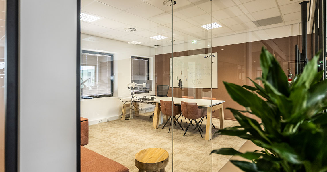 Custom whiteboard wall in a copper-toned glass meeting room