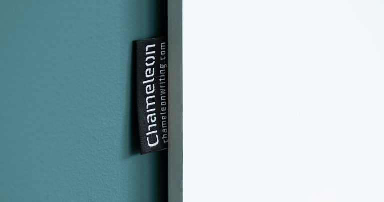 Detail shot of a frameless whiteboard's mounting edge with a Chameleon brand label
