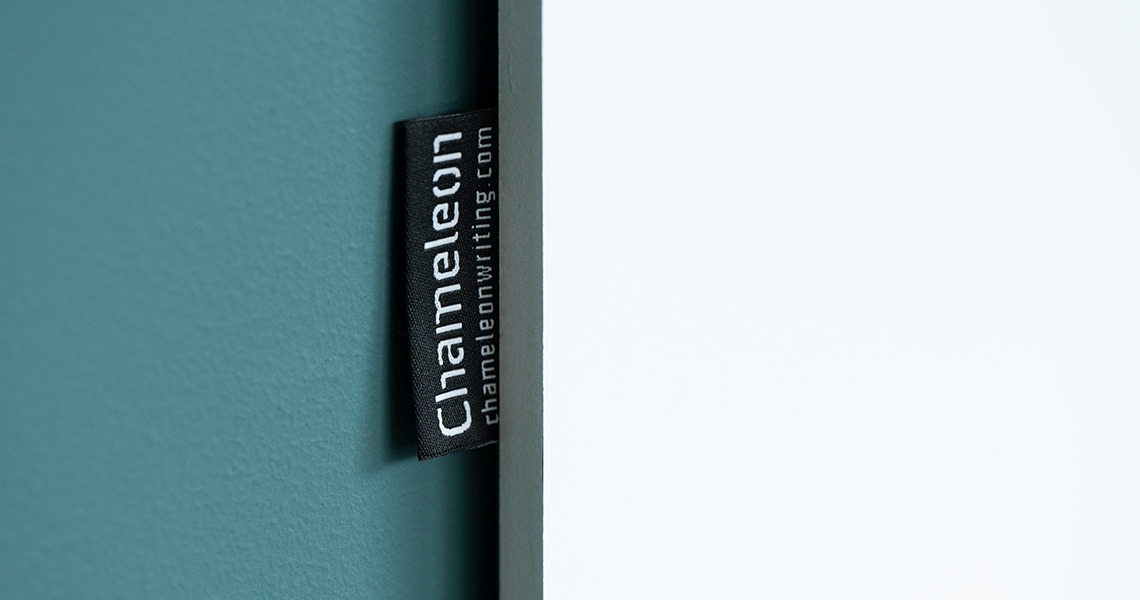 Detail shot of a frameless whiteboard's mounting edge with a Chameleon brand label