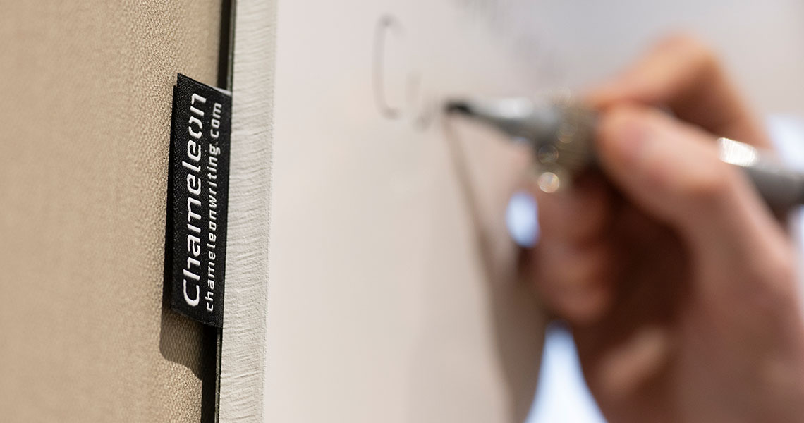 Frameless whiteboard with markers and eraser mounted alongside the panel