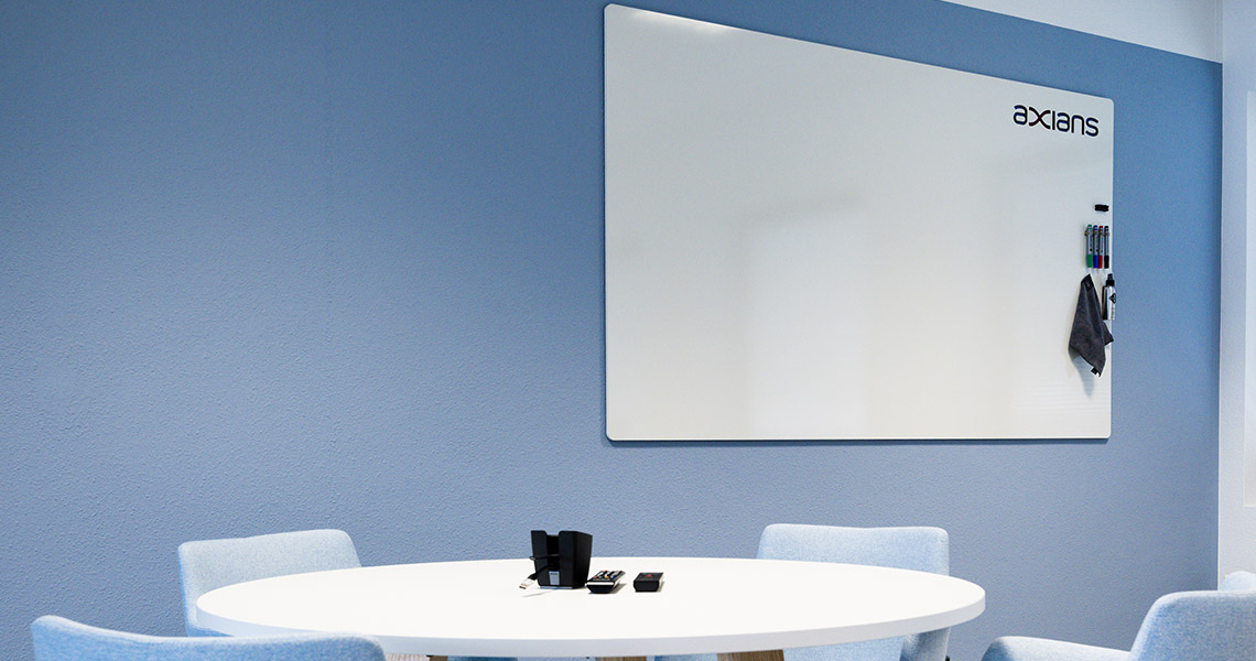 Colleagues gathered around a large dry erase board for a brainstorm