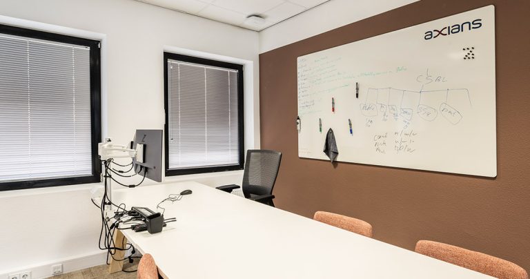 Large dry erase board with colour-coded markers and sticky notes