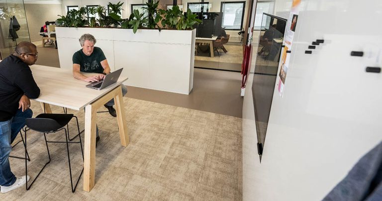 Large dry erase board used for a daily stand-up meeting