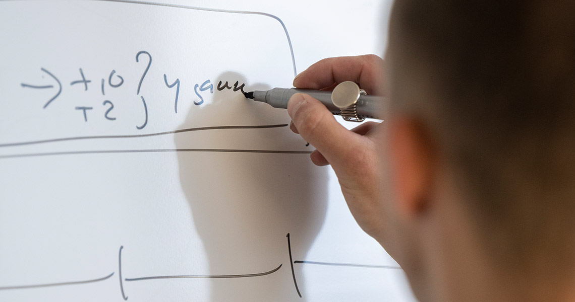Detail of a large dry erase board's frame and mounting hardware