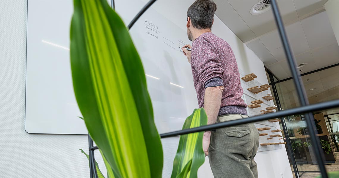 Large magnetic board mounted on an office wall for team collaboration