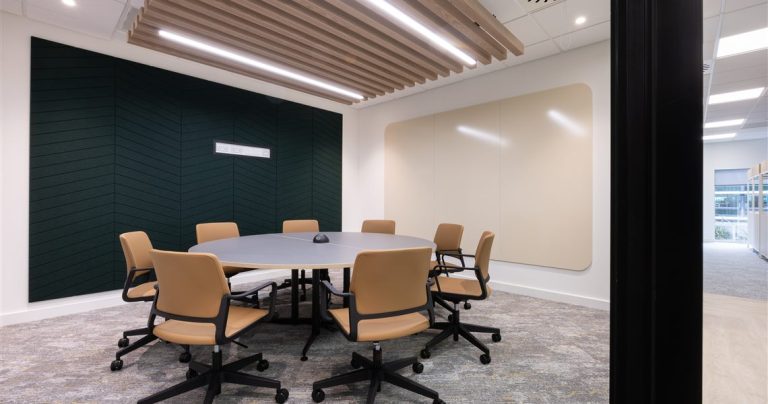 SatinTones ceramic steel whiteboard beside a dark green PET acoustic wall panel in a Suntera meeting room