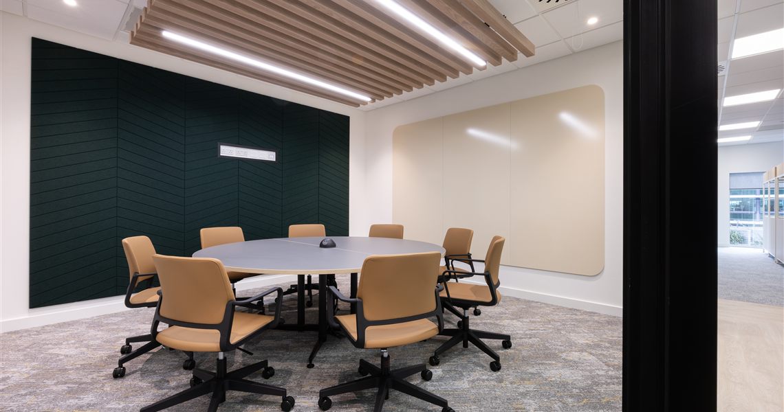 SatinTones ceramic steel whiteboard beside a dark green PET acoustic wall panel in a Suntera meeting room