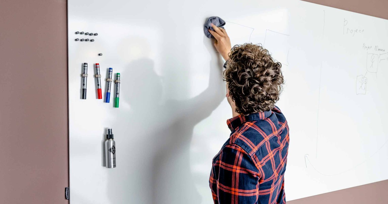Whiteboard wall installed across an office wall