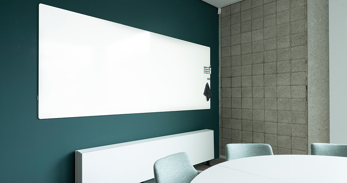 Whiteboard wall installed across an office wall