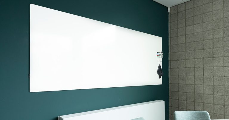 Whiteboard wall installed across an office wall