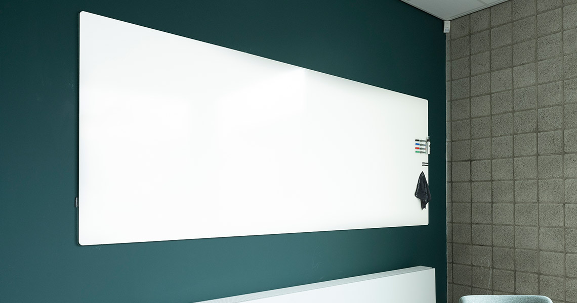 Whiteboard wall installed across an office wall