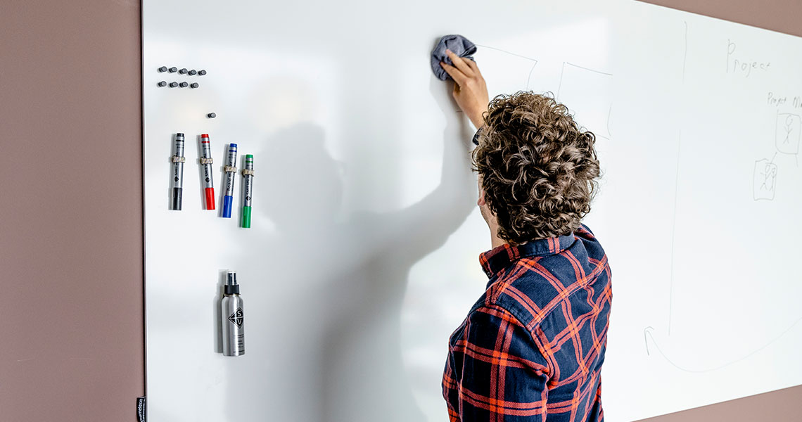 Whiteboard wall installed across an office wall
