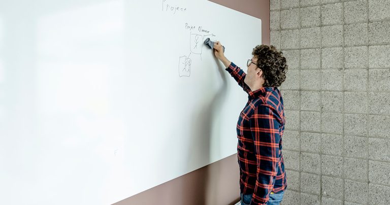Whiteboard wall installed across an office wall