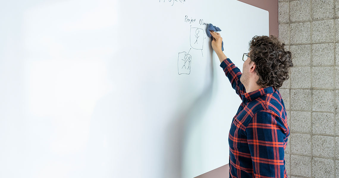 Whiteboard wall installed across an office wall