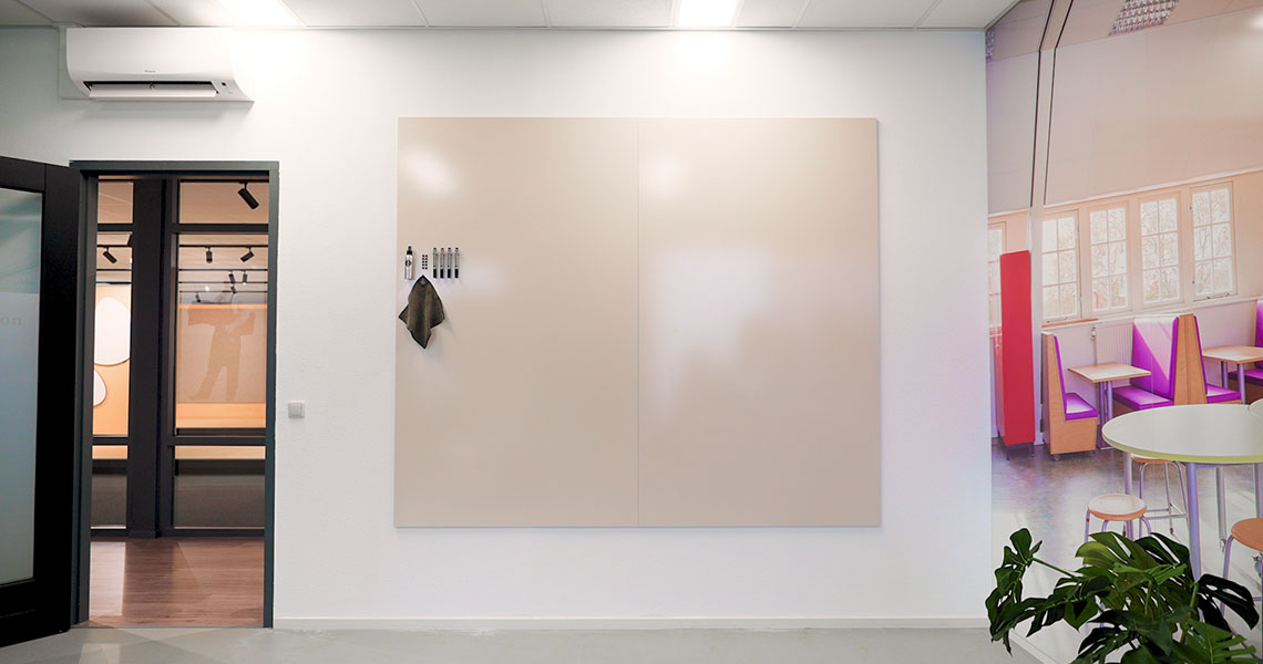 Wide view of a whiteboard wall installation in an open office layout