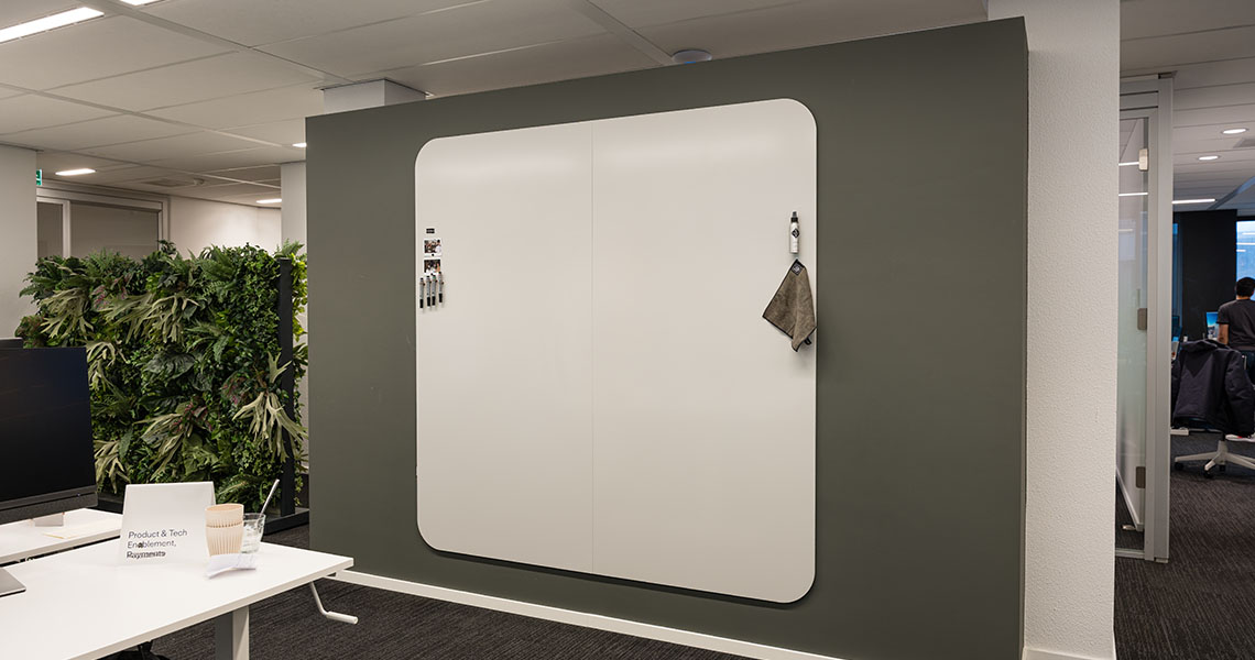 Whiteboard wall with visible panel join in a project team room