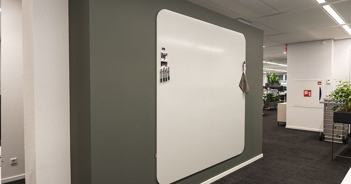 Whiteboard wall mounted in a naturally lit office space