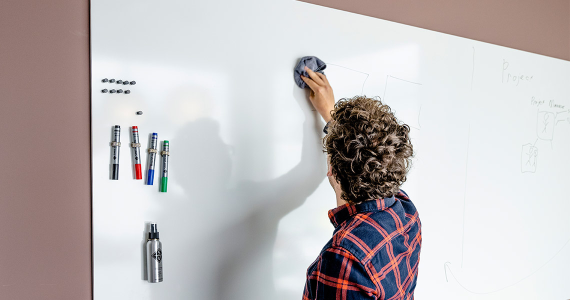 Whiteboard wall installed across an office wall