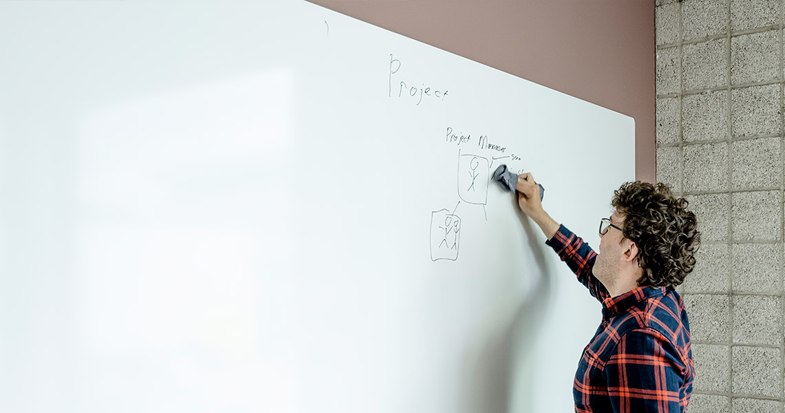 Whiteboard wall installed across an office wall