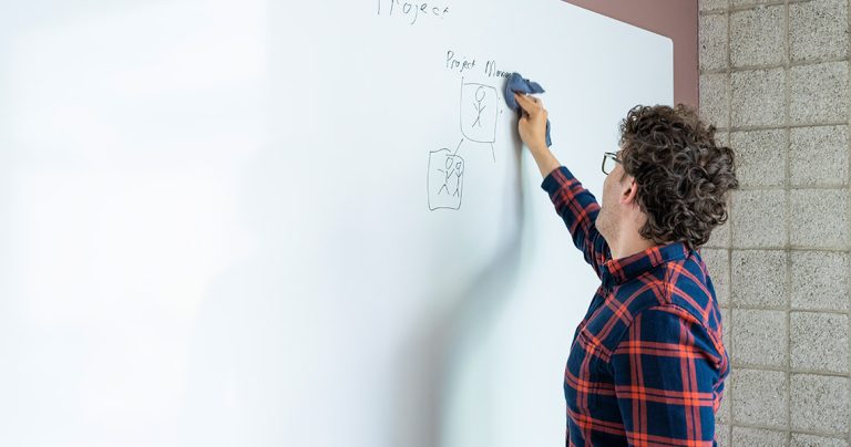 Whiteboard wall installed across an office wall