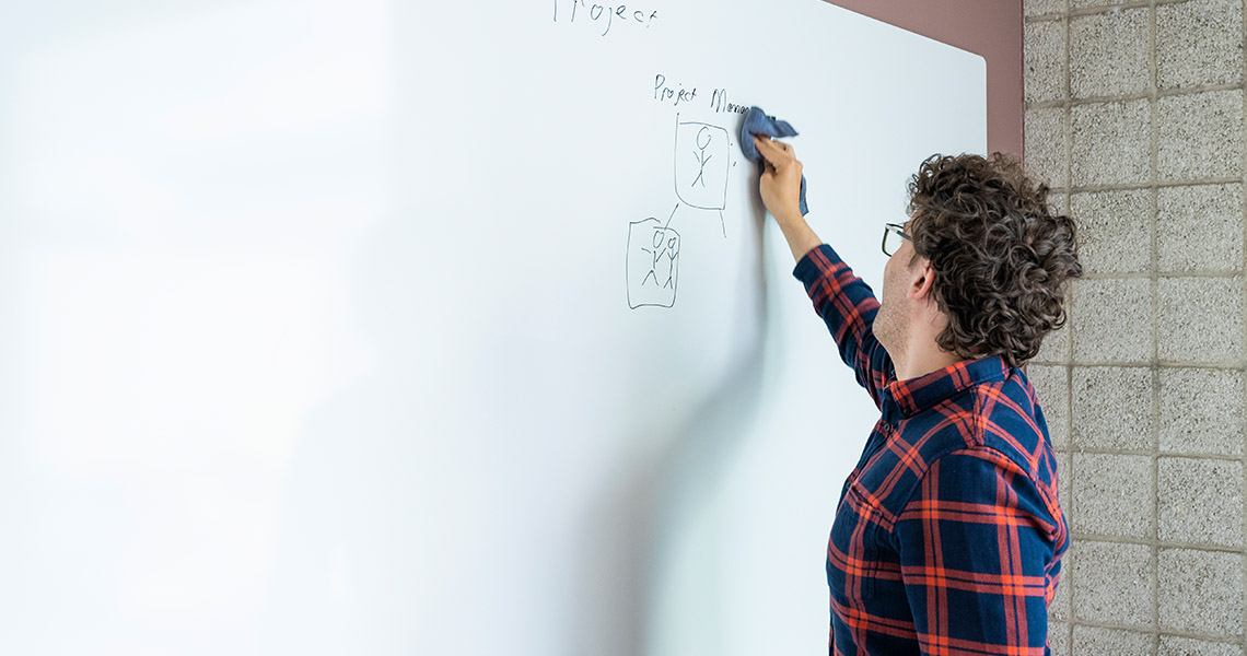Whiteboard wall installed across an office wall