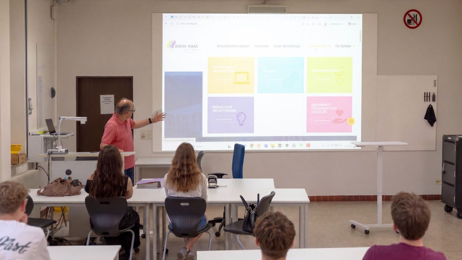Teacher using a Chameleon Projection whiteboard as a projector screen in a classroom