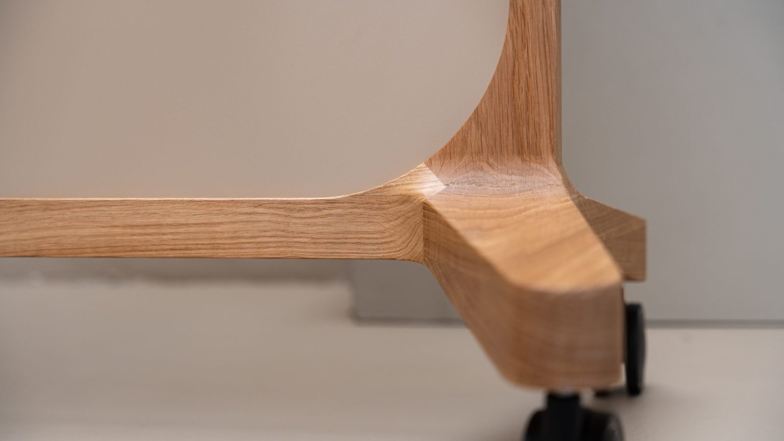 Low-angle view of the wheels and base of a mobile whiteboard