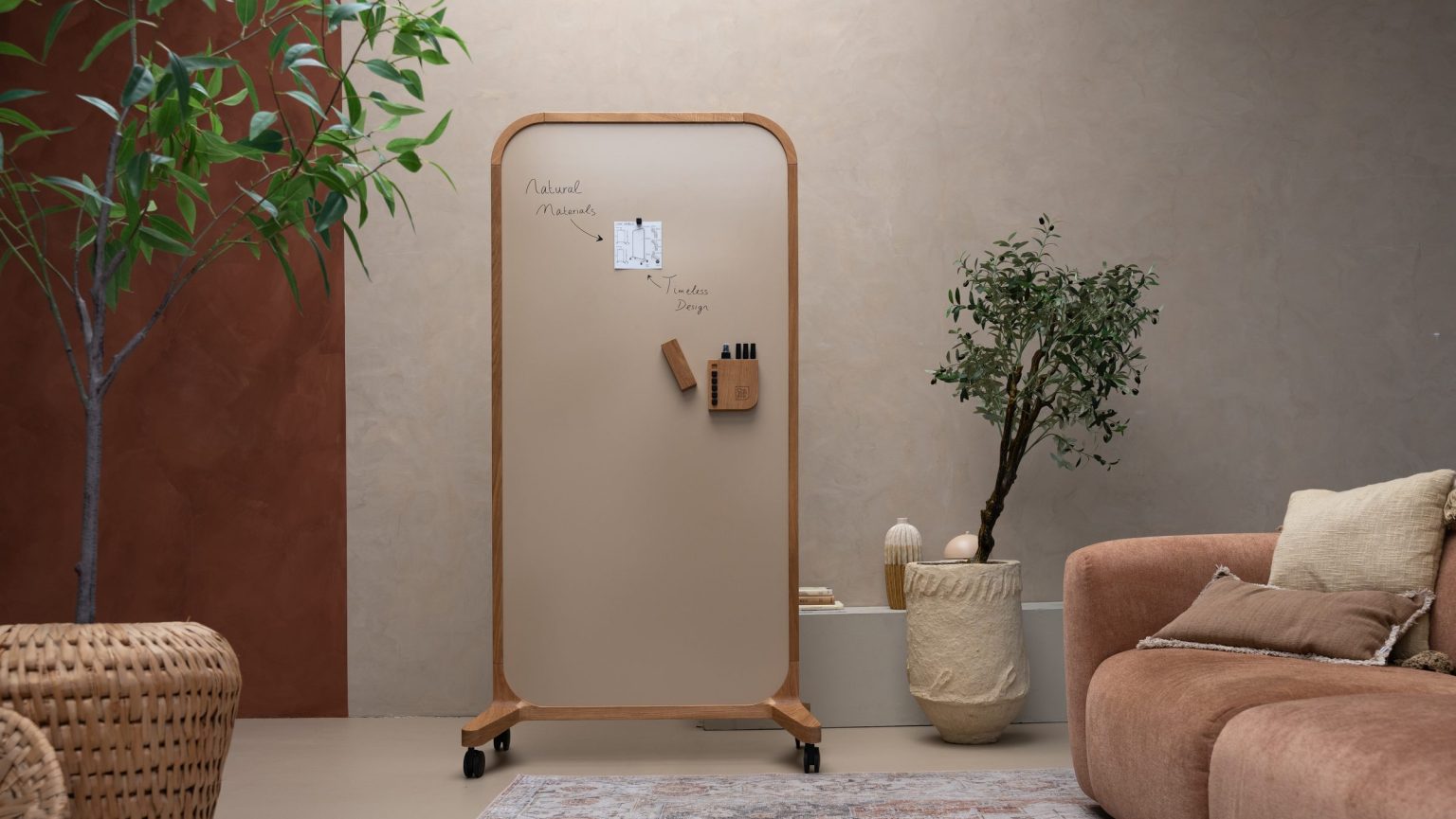 Mobile whiteboard on wheels in a warm corner with an olive tree