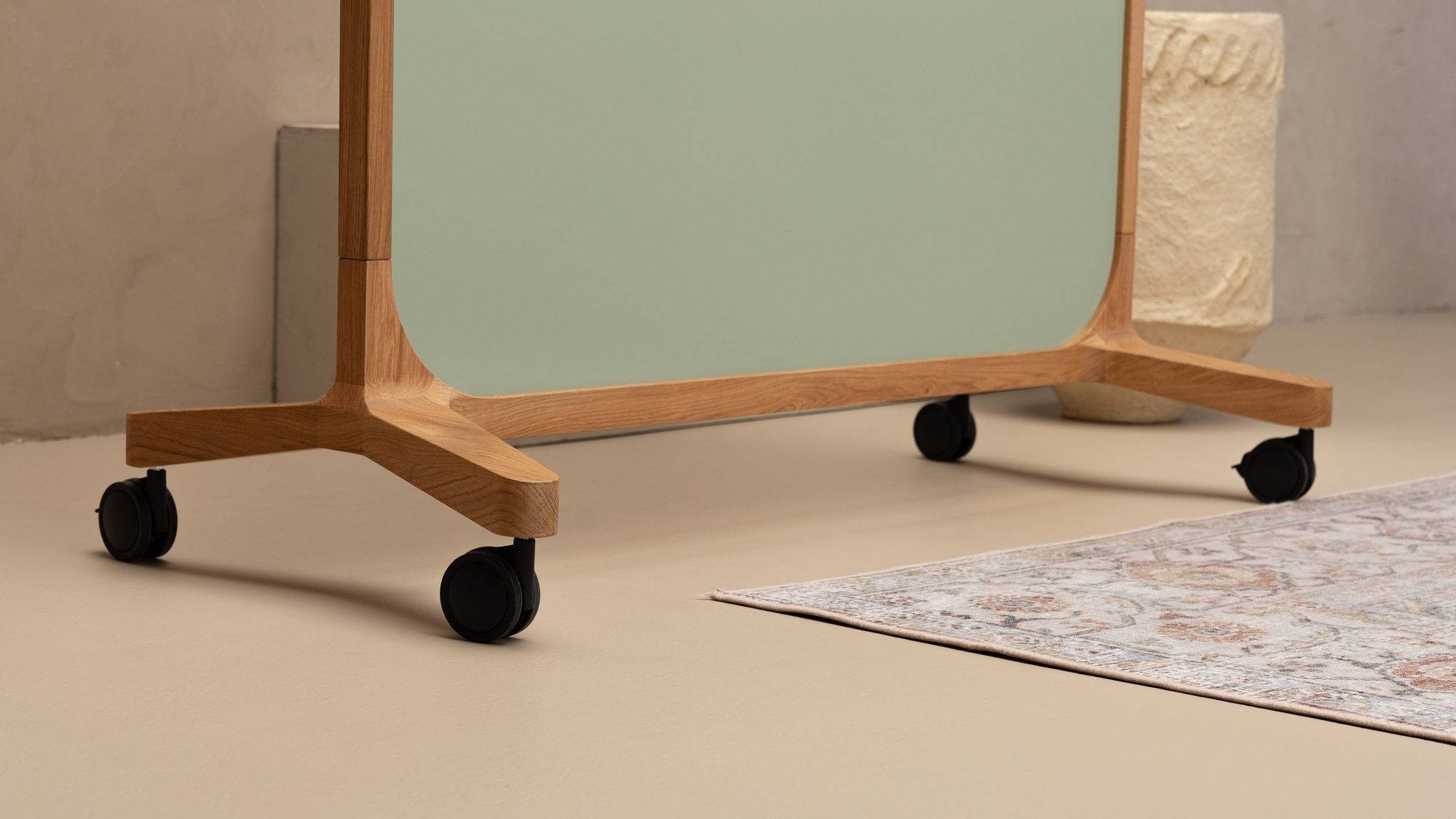 Sage green Oak Mobile board on castors on a rug